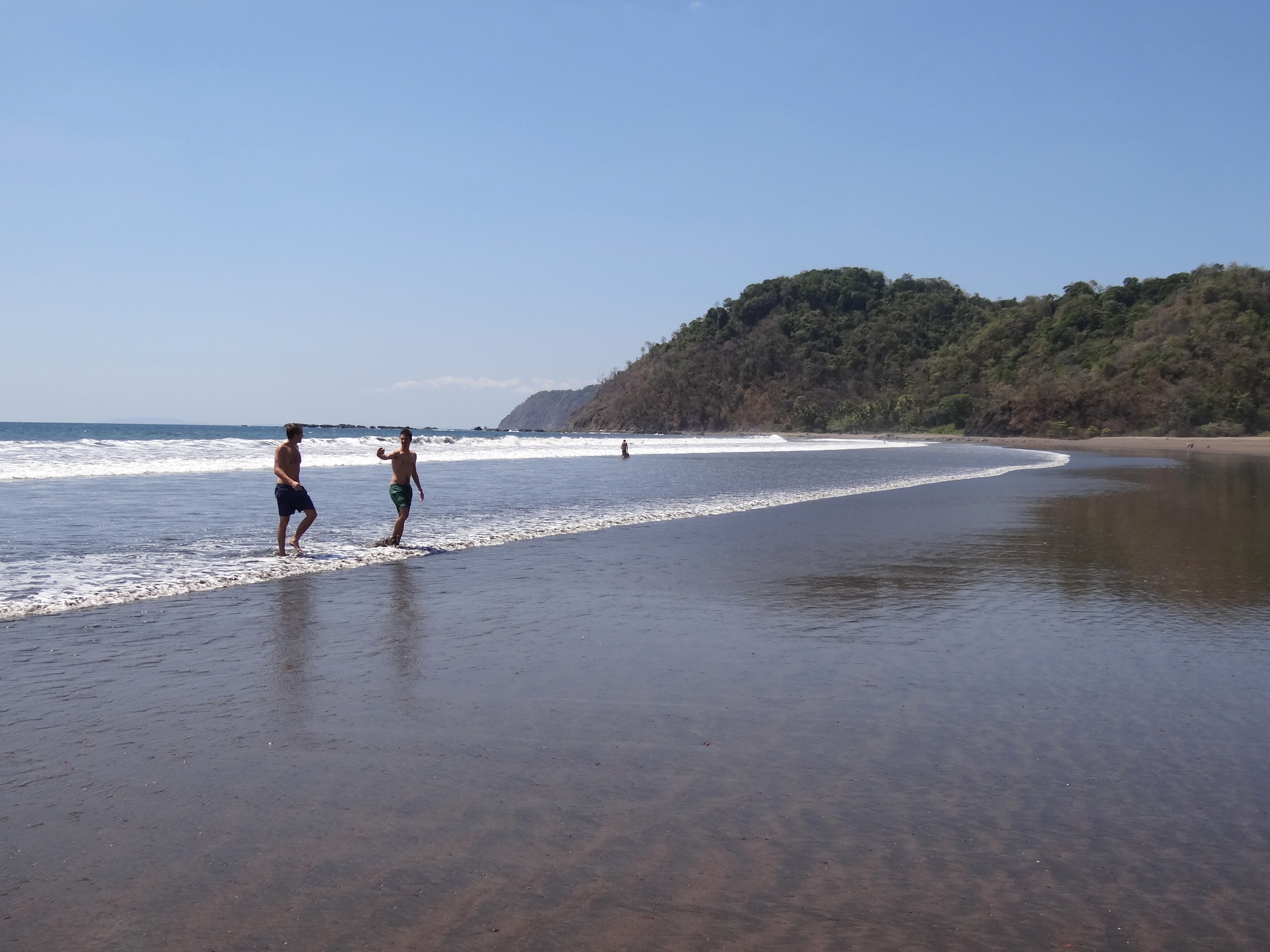 Wide sand and gentle surf at Jaco Beach
